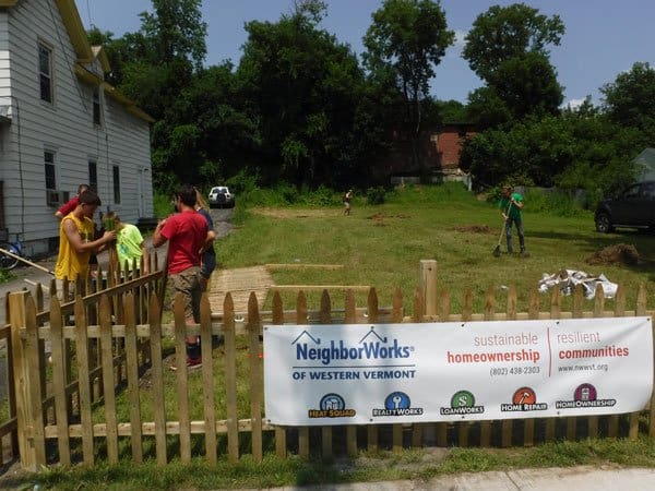 NeighborWorks of Western Vermont volunteers installing a fence in Rutland